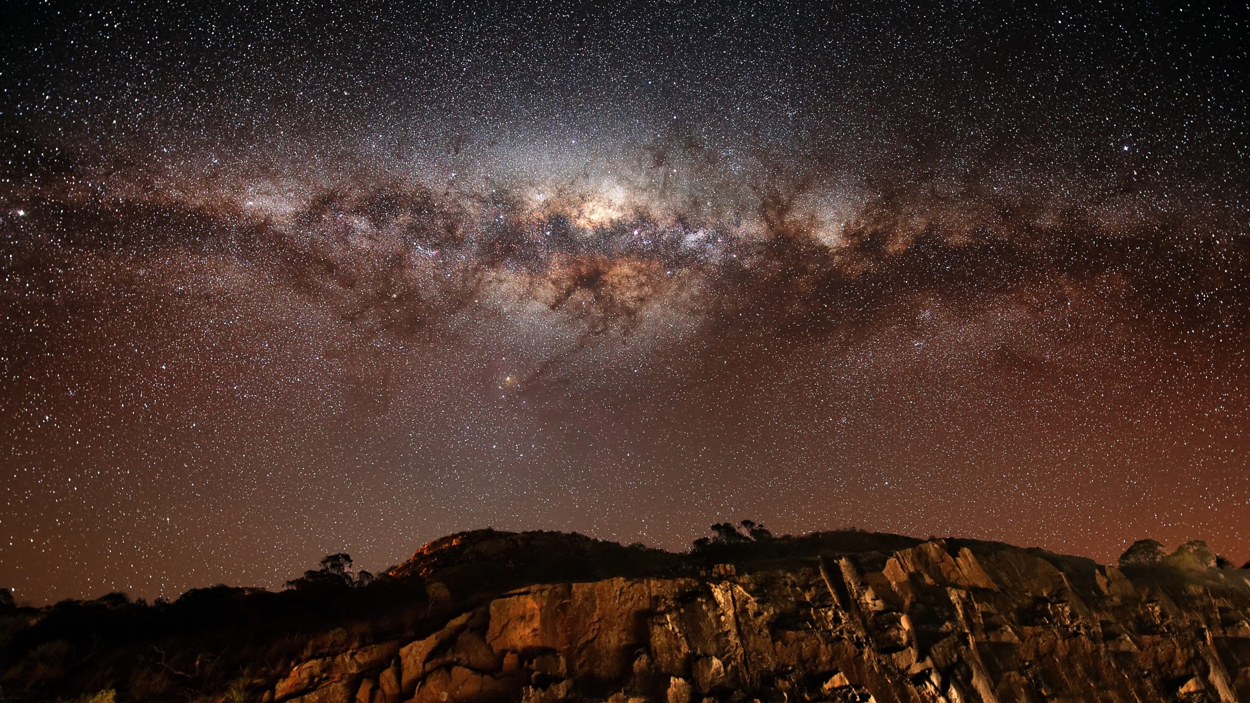 Milky Way galaxy, galactic core dust lanes, rocky ridge outcrop, HD Desktop wallpaper