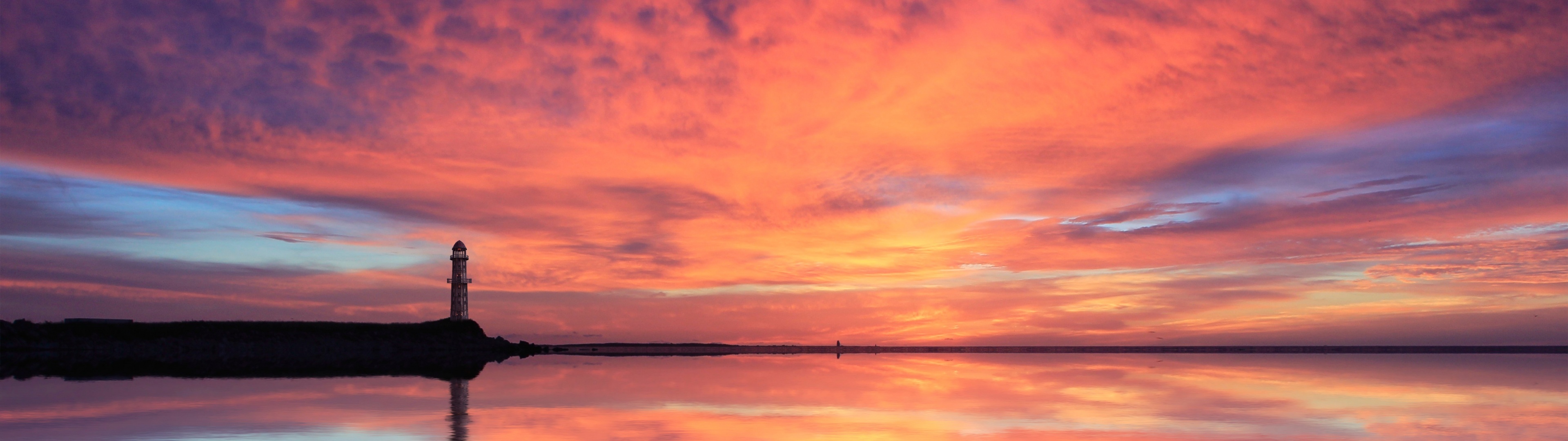 coastal lighthouse silhouette, vibrant pink sunset sky, calm sea reflection, Dual Screen Desktop wallpaper