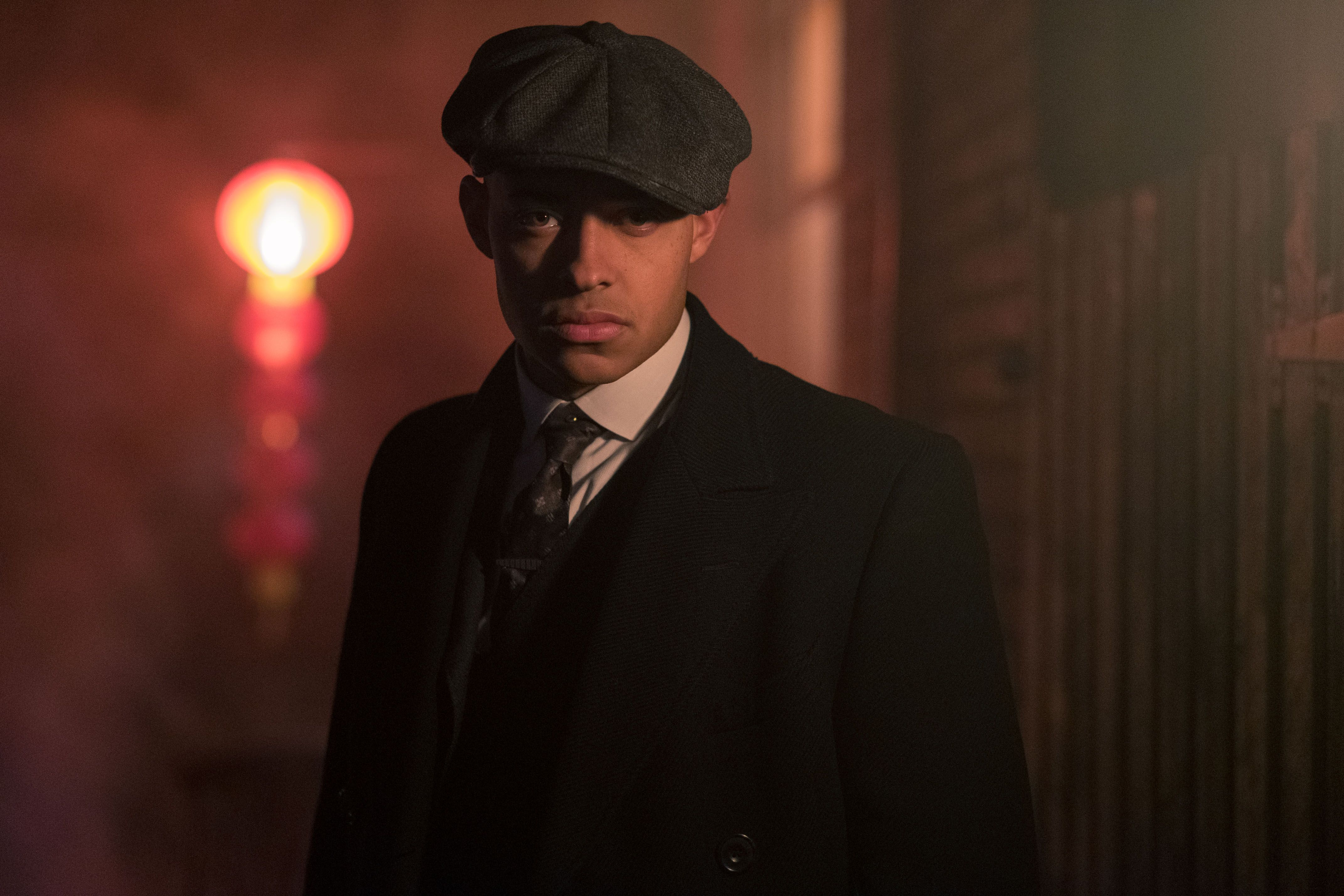 Isiah Jesus, Flat cap and dark overcoat, Glowing red lantern behind, 4K Desktop wallpaper