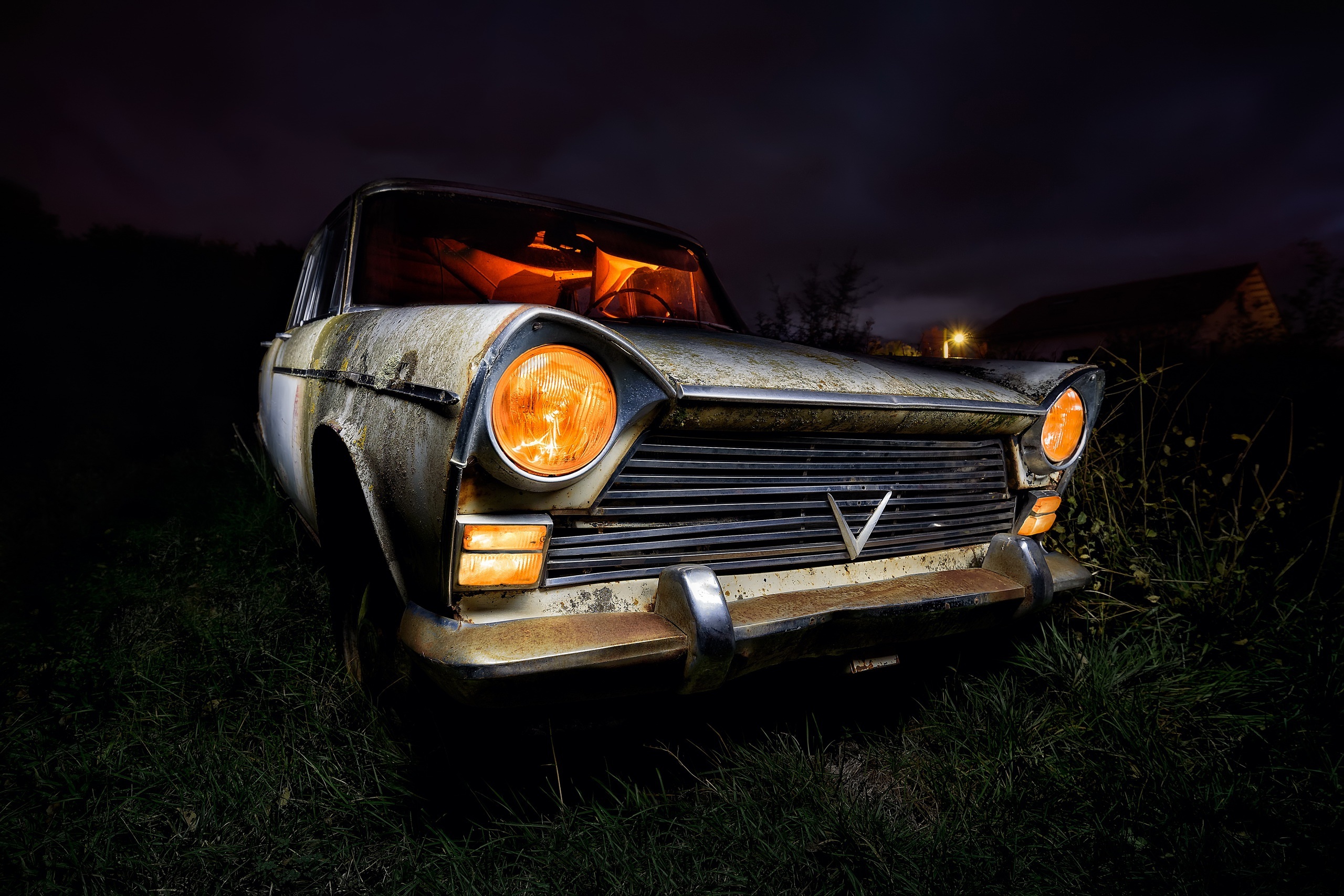 abandoned vintage sedan, illuminated amber headlights, overgrown night field, HD Desktop wallpaper