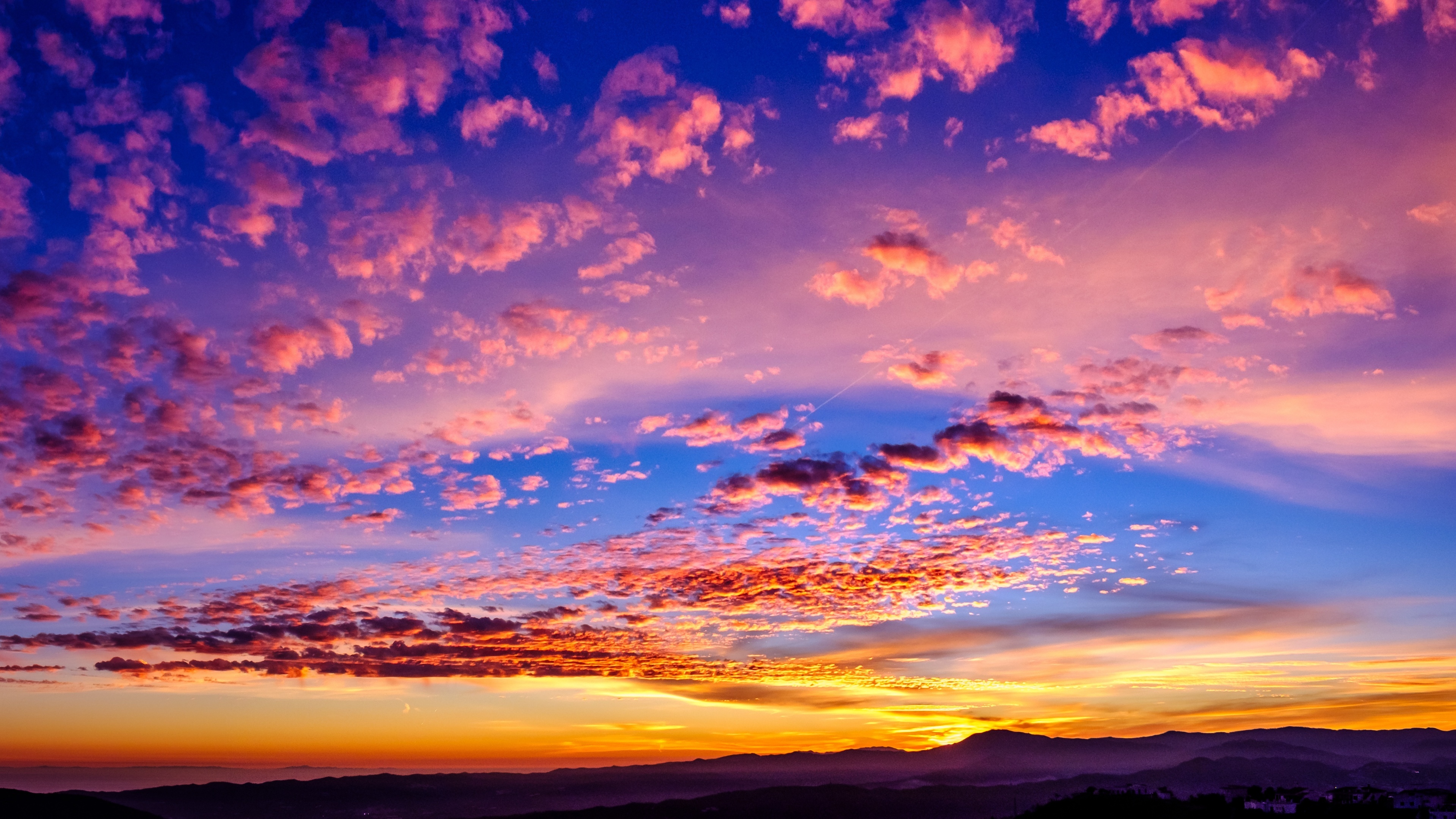 pink scattered sunset clouds, silhouetted mountain ridges, vibrant twilight gradient, 4K Desktop wallpaper