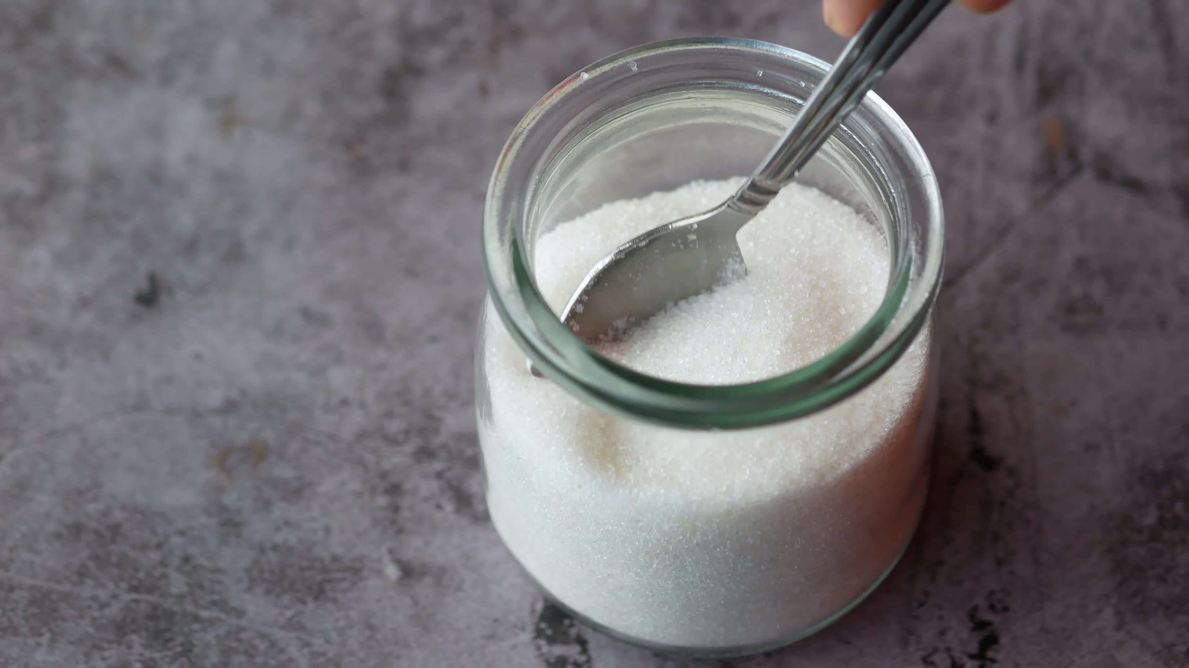 White sugar, Spoon in container, Black background, Stock video, 3840x2160 4K Desktop