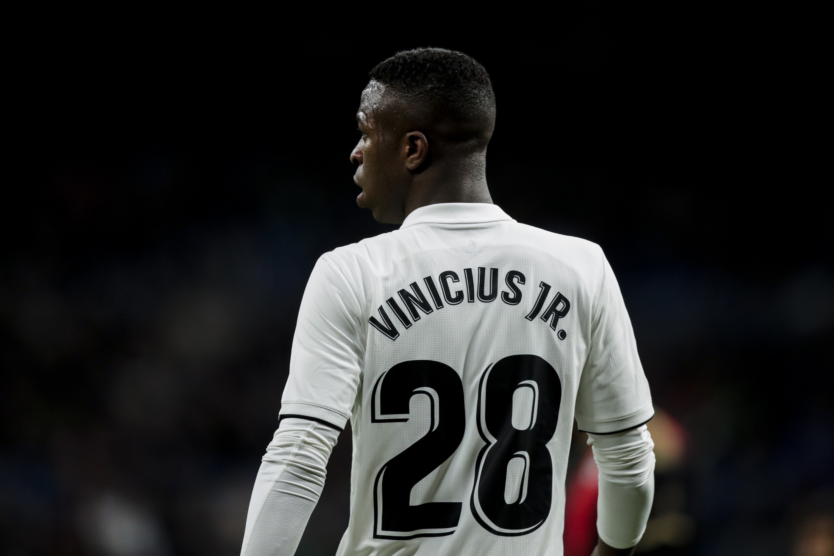 Vinicius Junior, Real Madrid 28 jersey, Dark football stadium background, HD Desktop wallpaper