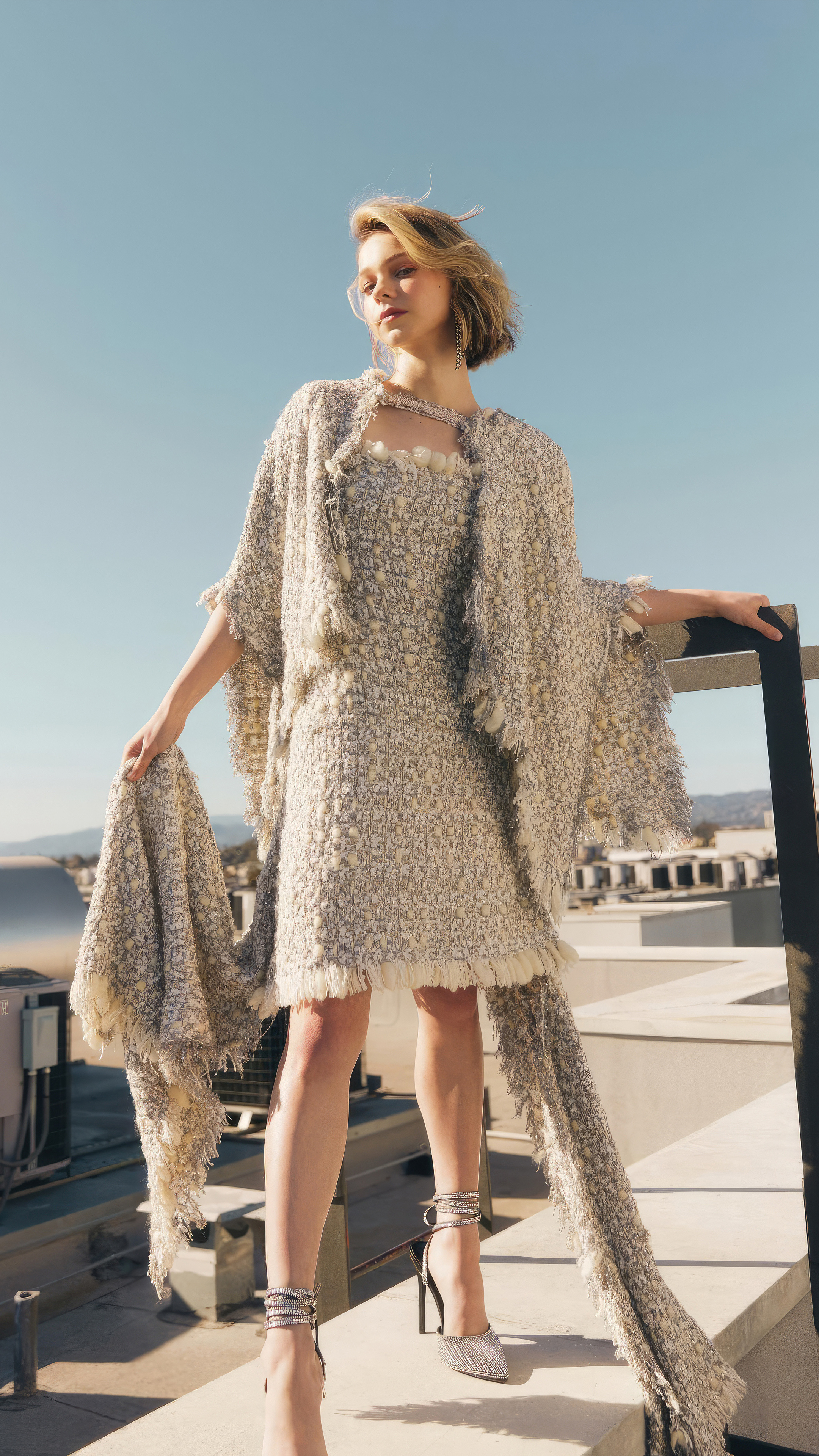 Emma Myers in boucle mini dress, Fringed tweed cape, Rooftop parapet above city, 4K Phone wallpaper