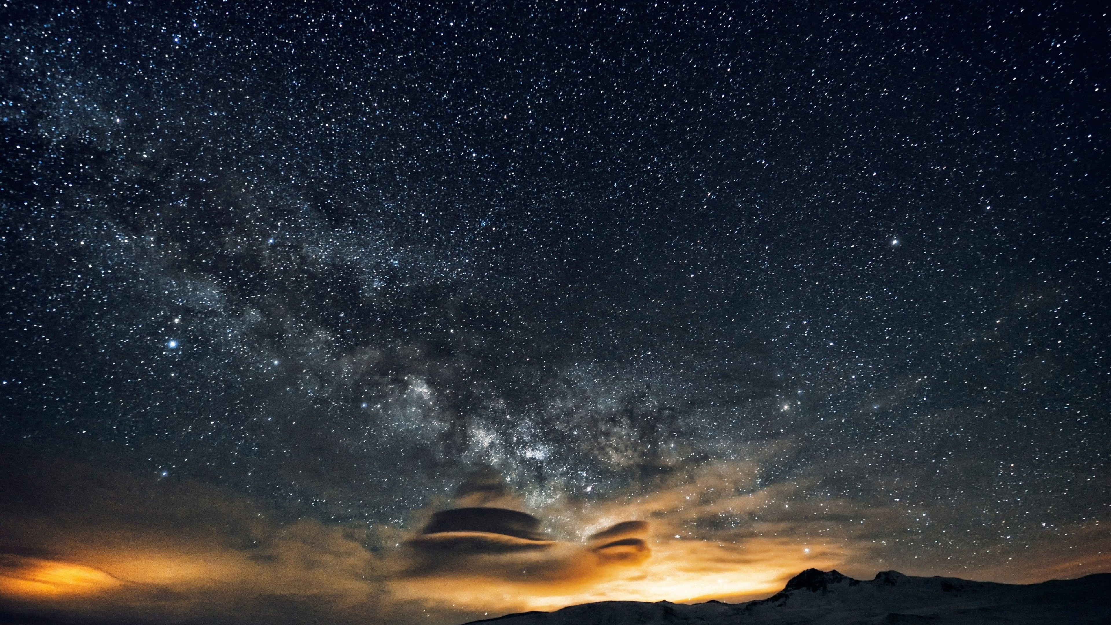 Milky Way galaxy, illuminated lenticular clouds, snow covered mountain ridge, 4K Desktop wallpaper