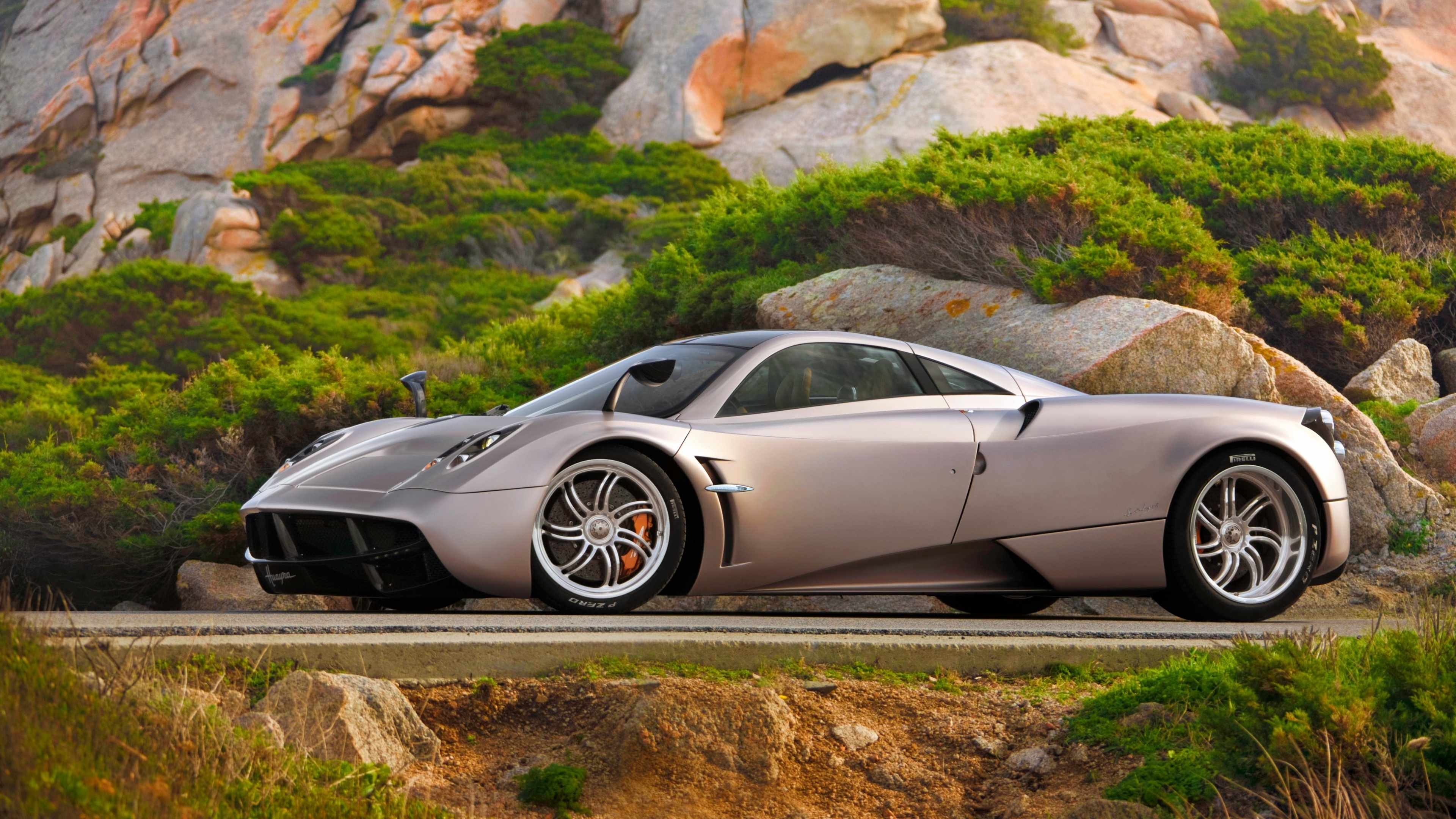 Pagani Huayra, Rocky hillside shrubs, Coastal asphalt road, 4K Desktop wallpaper