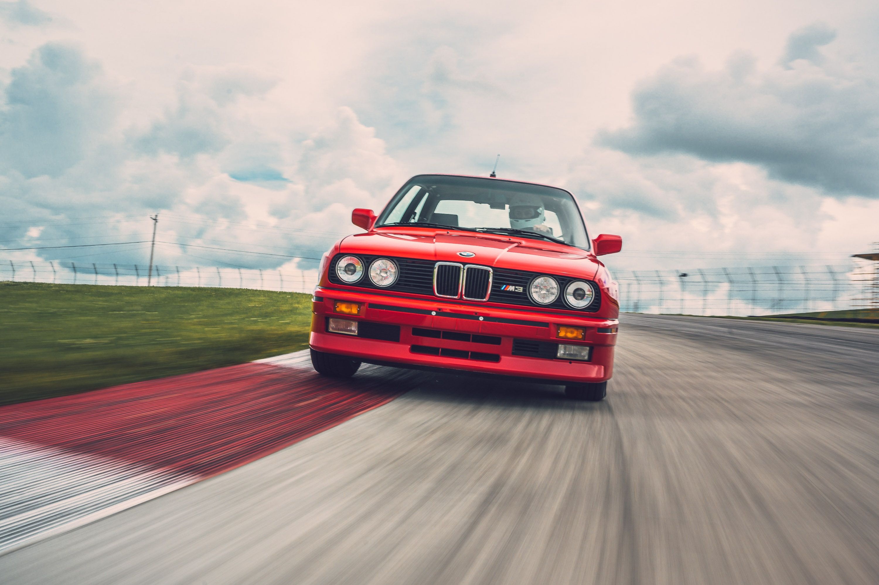 red BMW E30 M3, race track kerbing, helmeted race driver, HD Desktop wallpaper