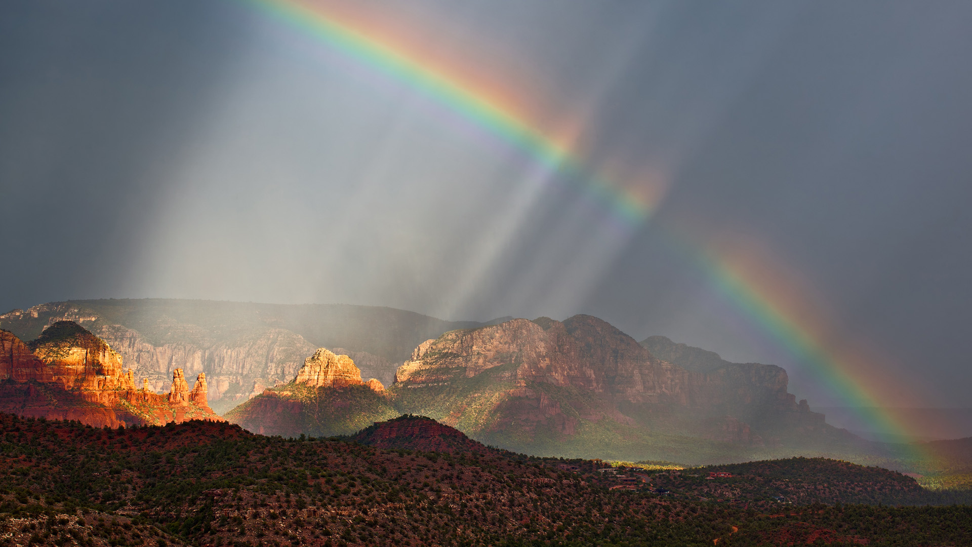 Sedona red rocks, Rainbow across dark sky, Sunlit sandstone mesas, Full HD Desktop wallpaper