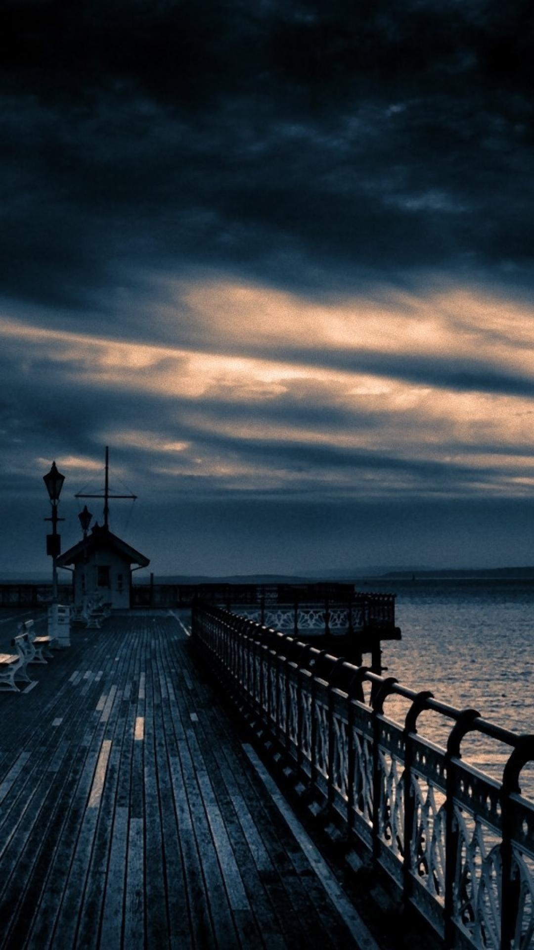 Moody ocean pier boardwalk, Ornamental iron pier railing, Dark twilight storm clouds, Full HD Phone wallpaper