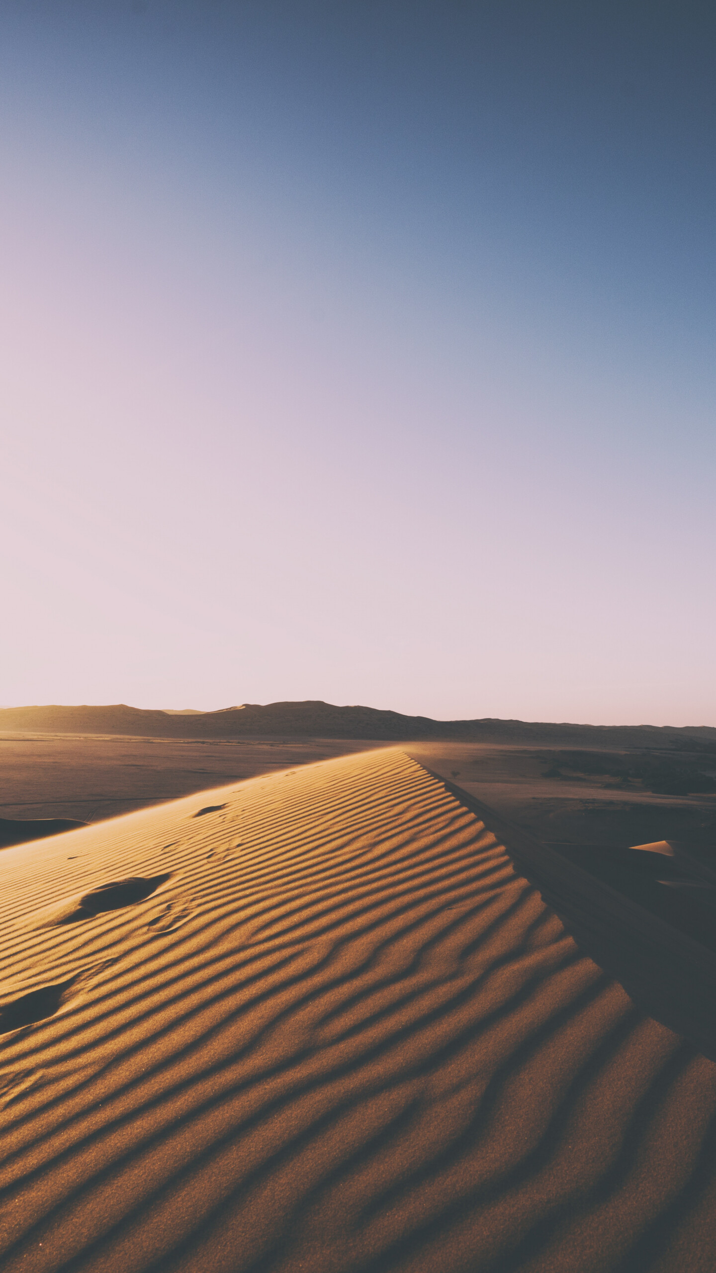 Desert sunset, Dramatic skyline, Silhouetted sand dunes, Breathtaking colors, 1440x2560 HD Phone