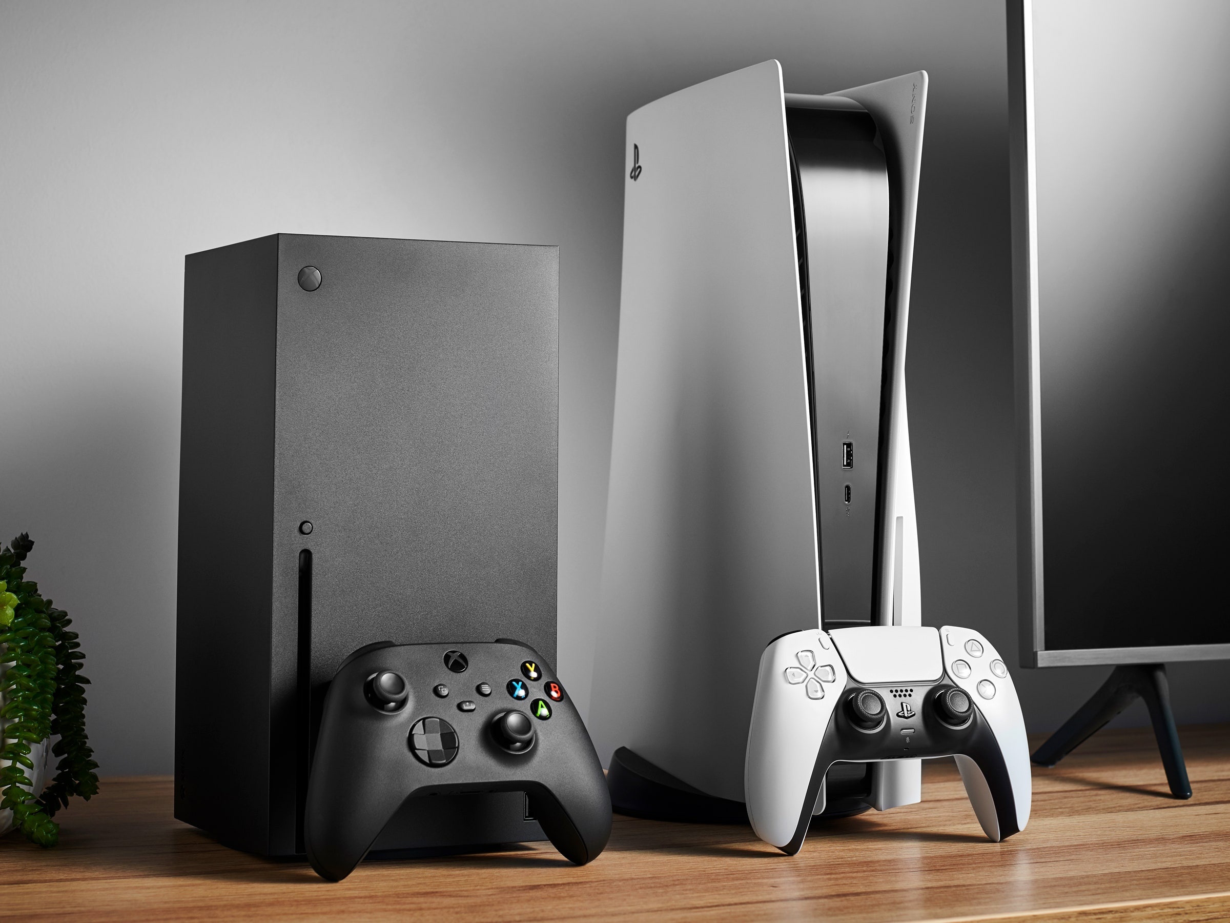 PlayStation 5 console, Xbox Series X console, DualSense wireless controller, Black Xbox controller, Wooden TV cabinet, HD Desktop wallpaper