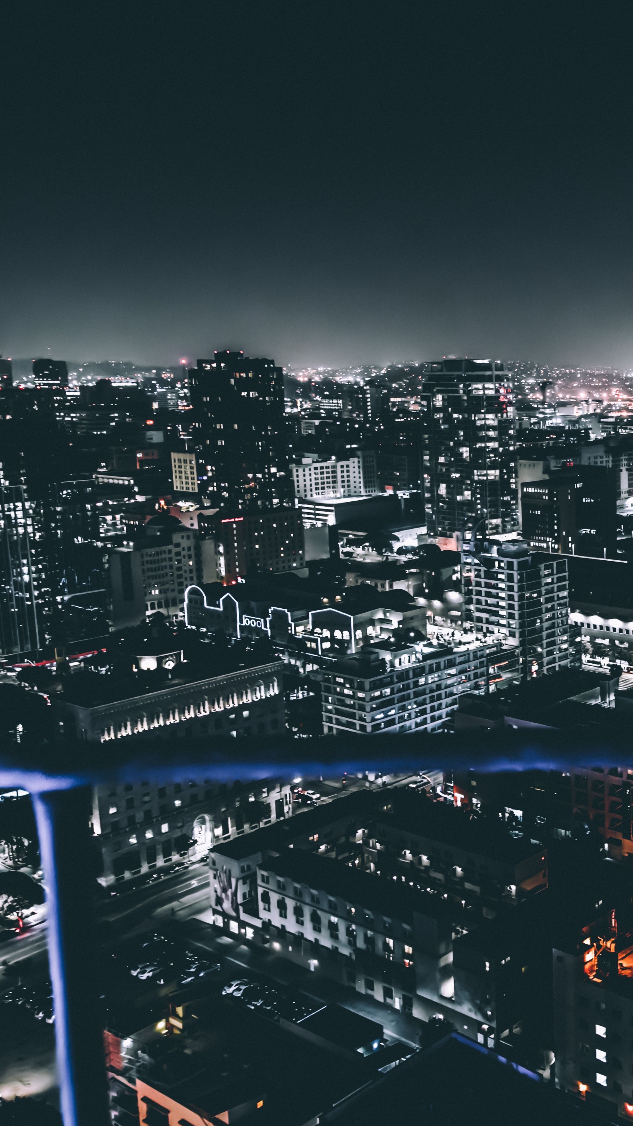 illuminated downtown skyscrapers, high-rise balcony view, nighttime urban grid, 4K Phone wallpaper