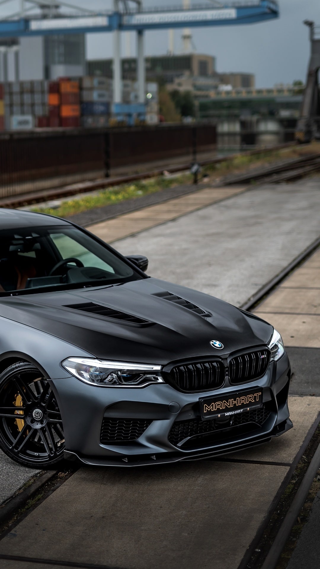 Manhart BMW M5 F90, MANHART front plate, industrial rail yard, Full HD Phone wallpaper
