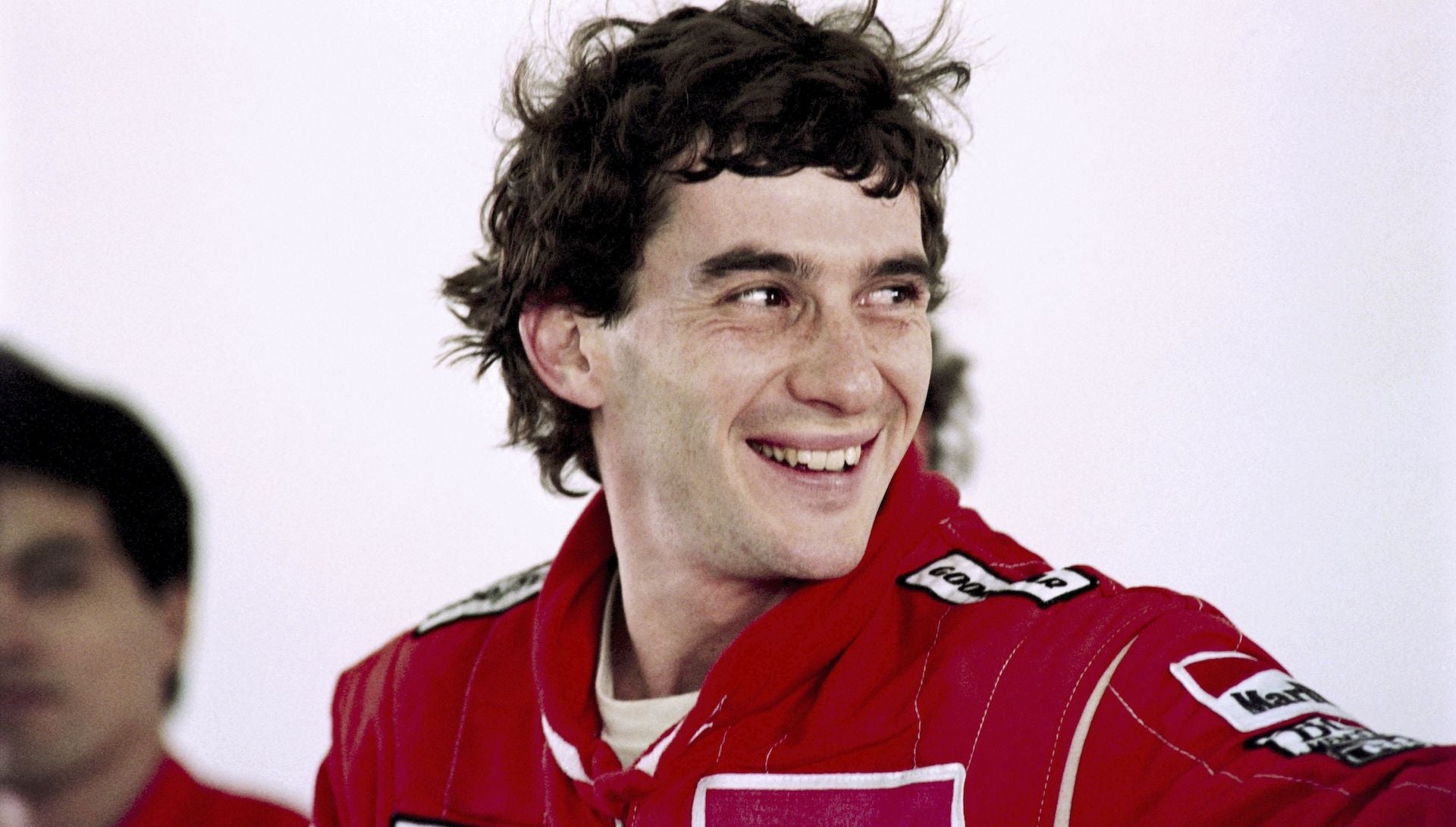 Ayrton Senna smiling portrait, Red McLaren Marlboro racing suit, Goodyear patch on race suit, HD Desktop wallpaper