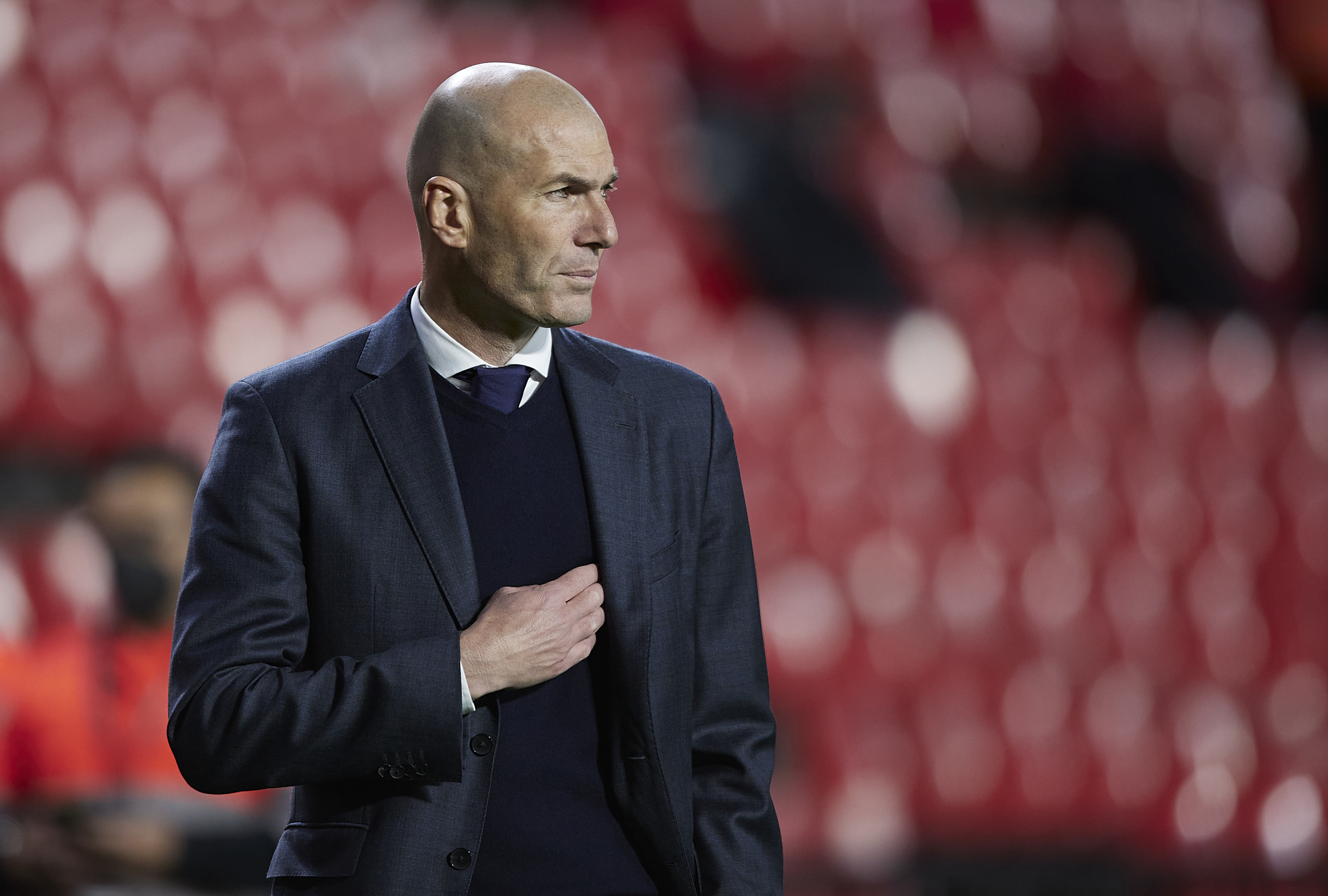 Zinedine Zidane, Navy blue suit jacket, Blurred red stadium seating, HD Desktop wallpaper