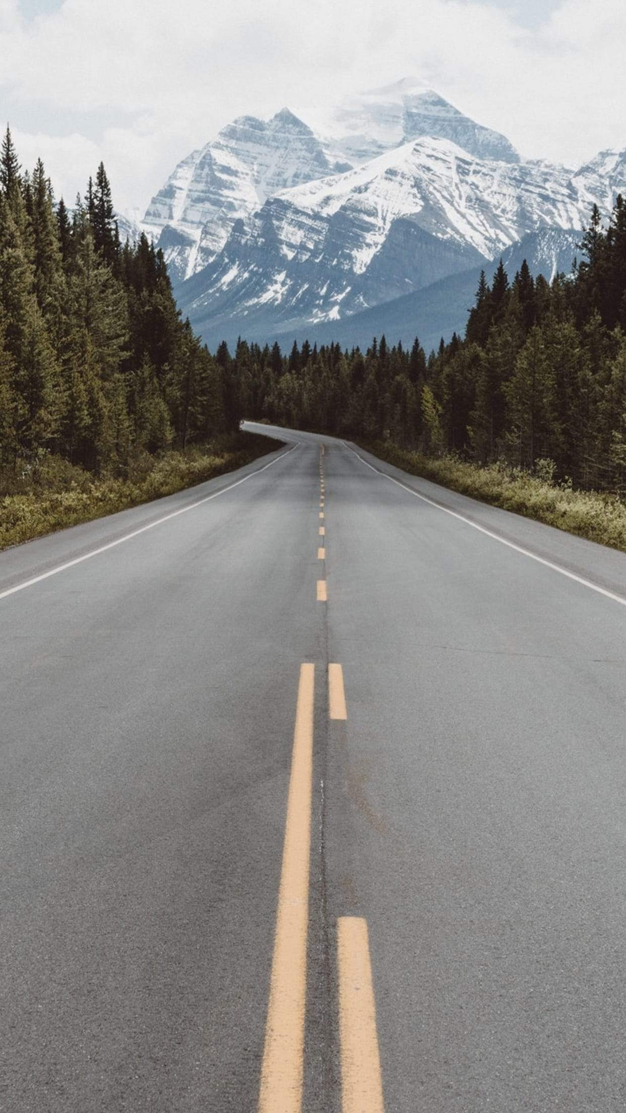 empty asphalt highway, snow-capped mountain peak, evergreen roadside forest, HD Phone wallpaper