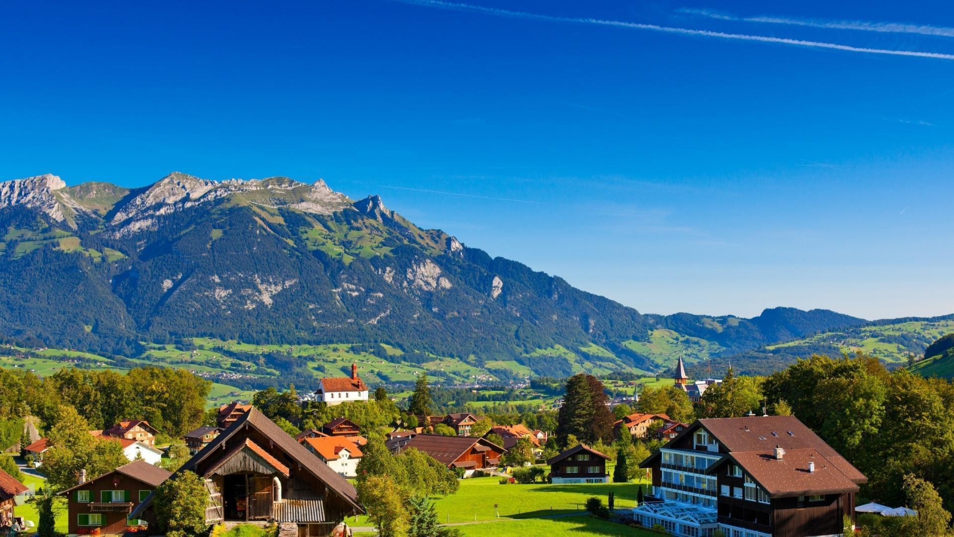 Swiss Alps mountain range, Traditional wooden alpine chalets, Lush green alpine meadow, Full HD Desktop wallpaper