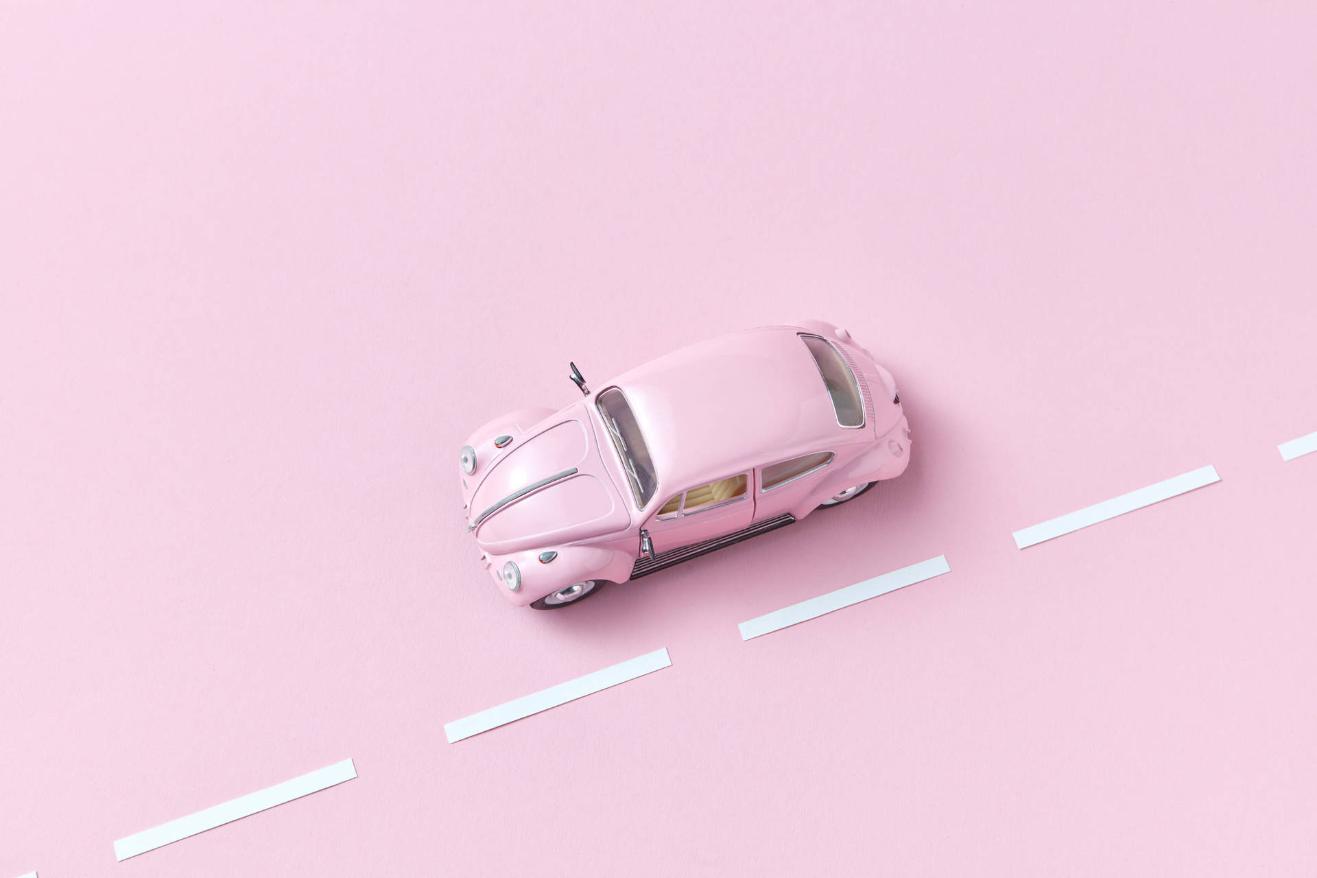 pink Volkswagen Beetle toy, white dashed lane markings, minimalist pastel pink surface, HD Desktop wallpaper