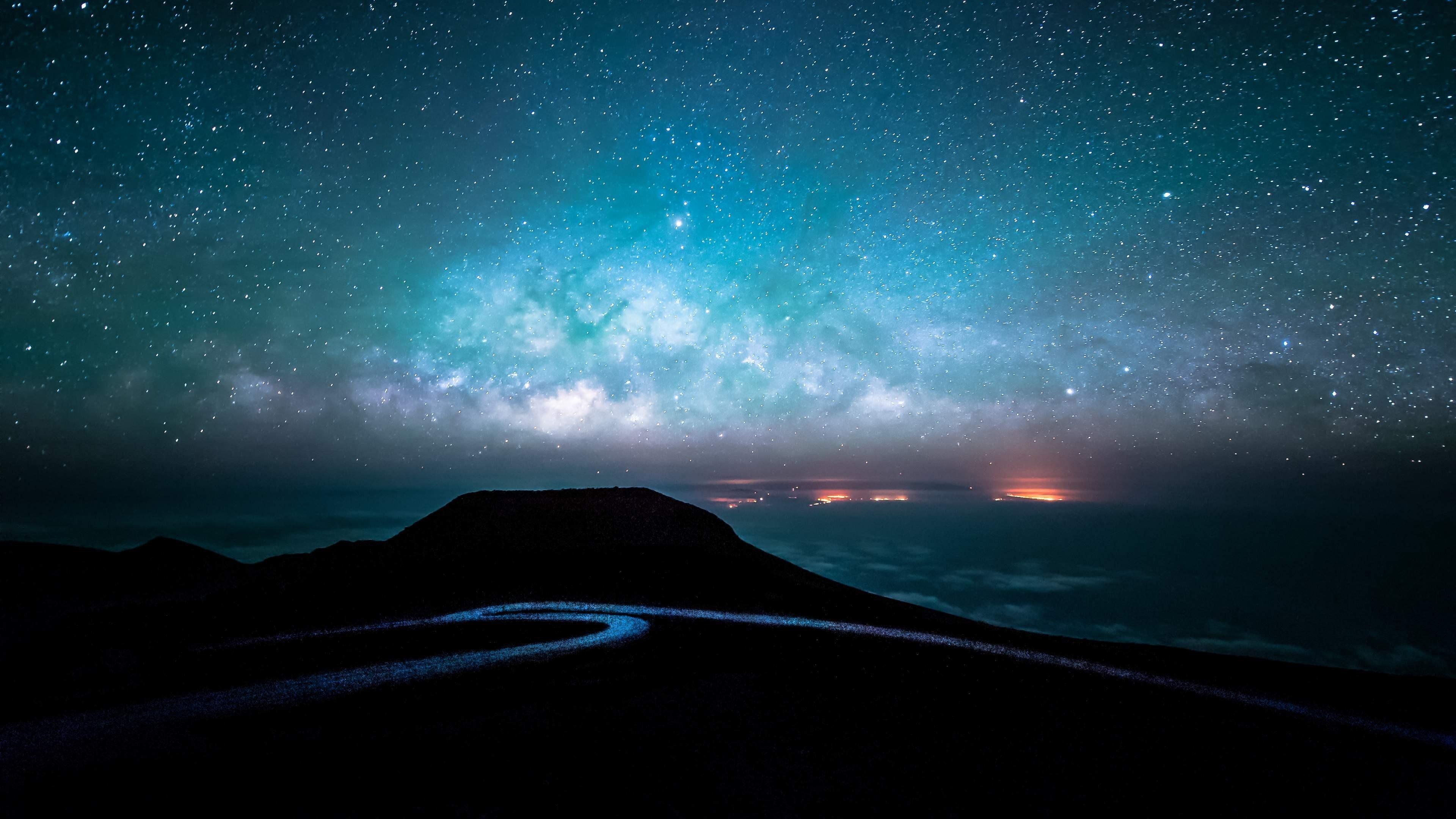 Milky Way galaxy, winding mountain summit road, silhouetted volcanic cinder cone, 4K Desktop wallpaper