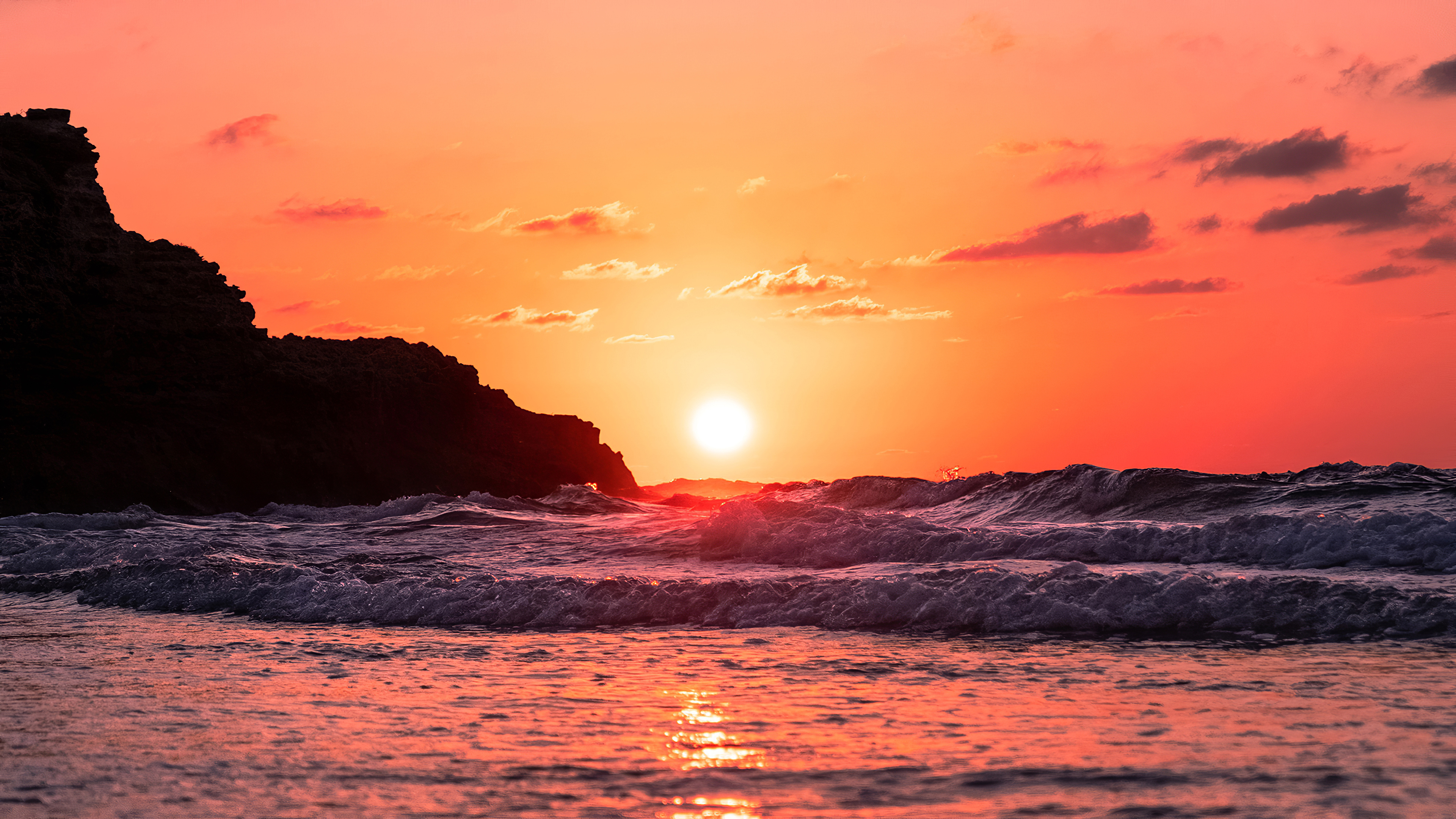 Setting sun over ocean, Foaming sea waves, Silhouetted coastal cliff, 4K Desktop wallpaper