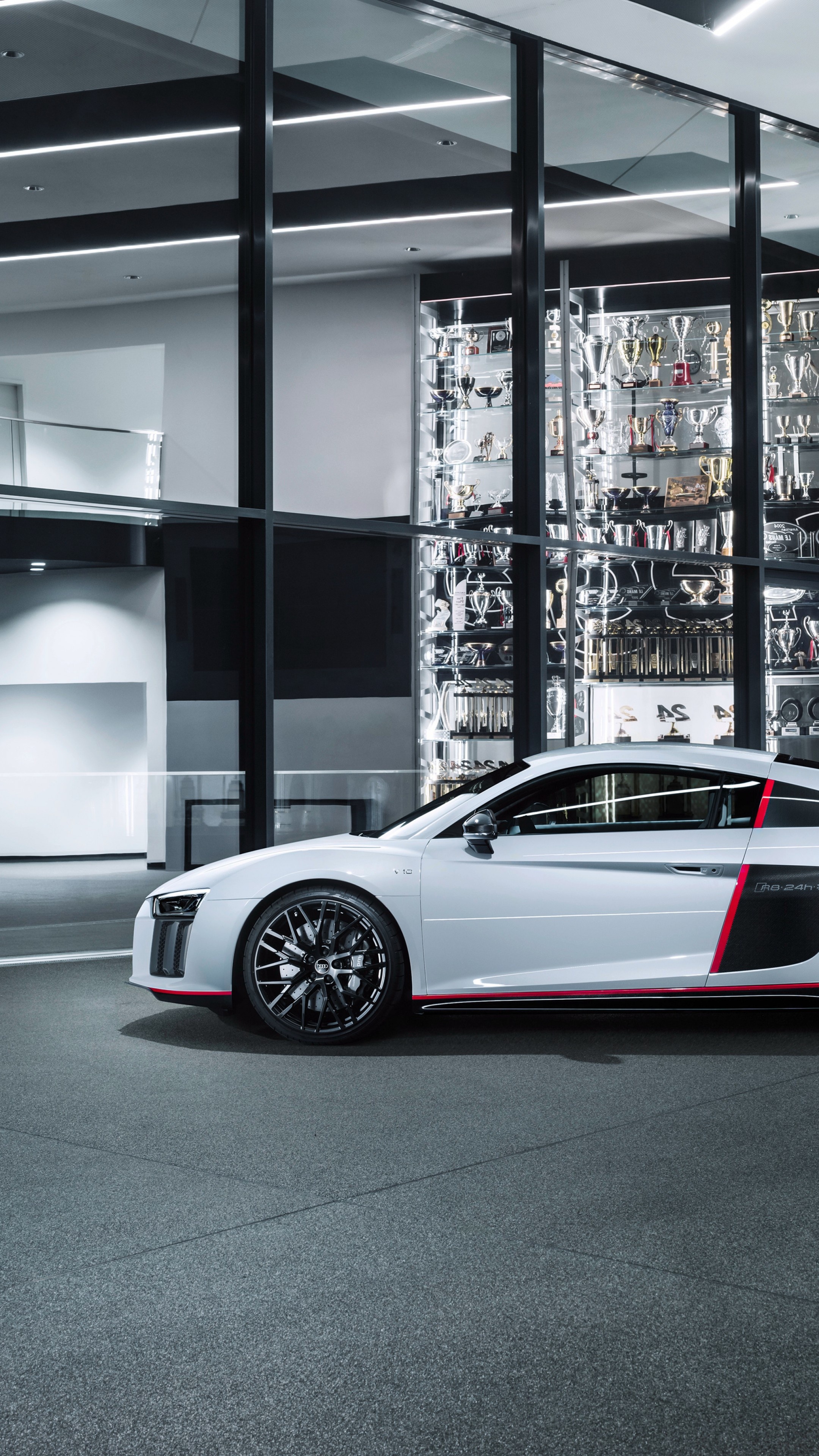 Audi R8 V10 plus selection 24h, glass trophy showcase, modern automotive showroom, 4K Phone wallpaper