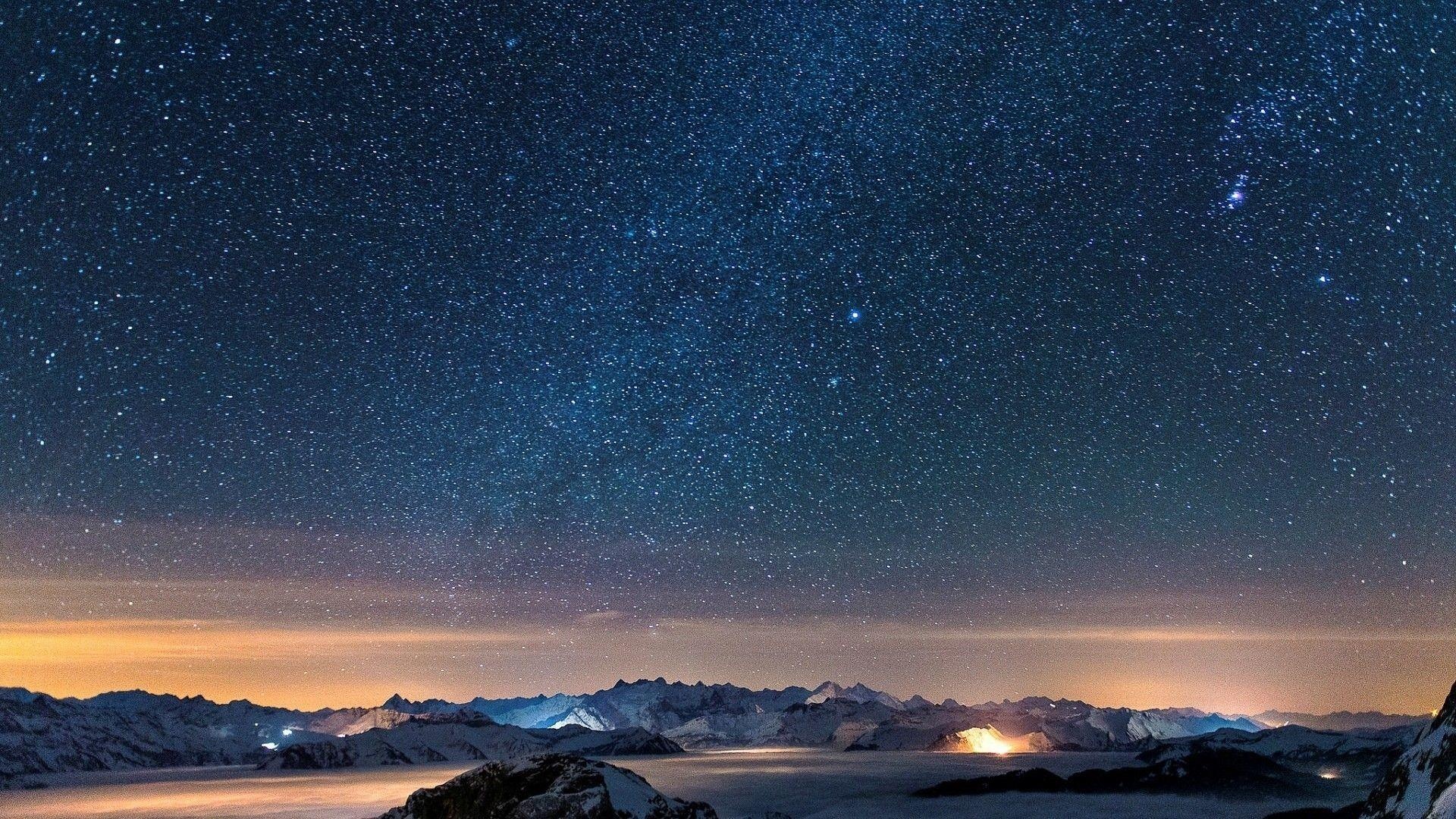 snow-covered mountain peaks, dense starry night sky, valley cloud inversion, Full HD Desktop wallpaper