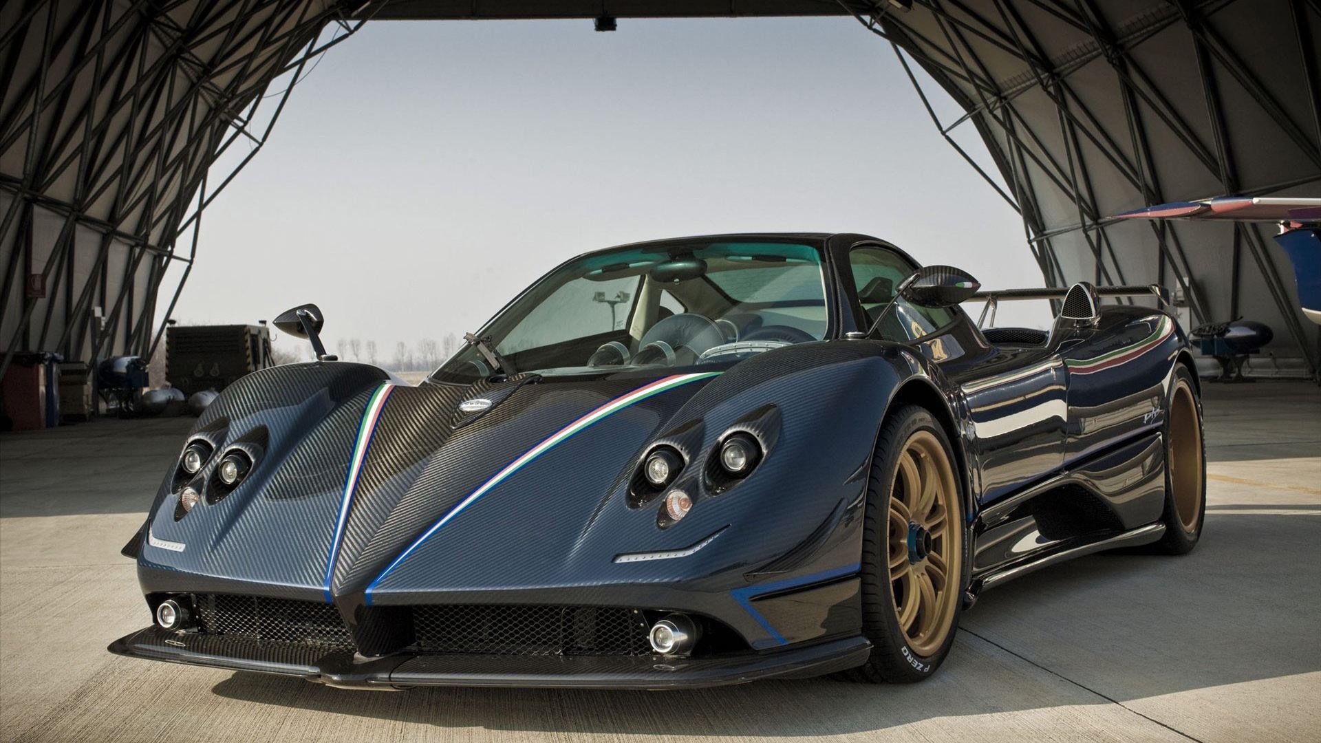 Pagani Zonda Tricolore, aircraft hangar, gold alloy wheels, Full HD Desktop wallpaper