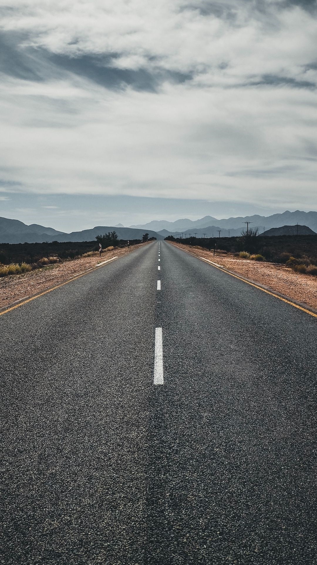 straight asphalt highway, distant mountain range, overcast cloudy sky, Full HD Phone wallpaper