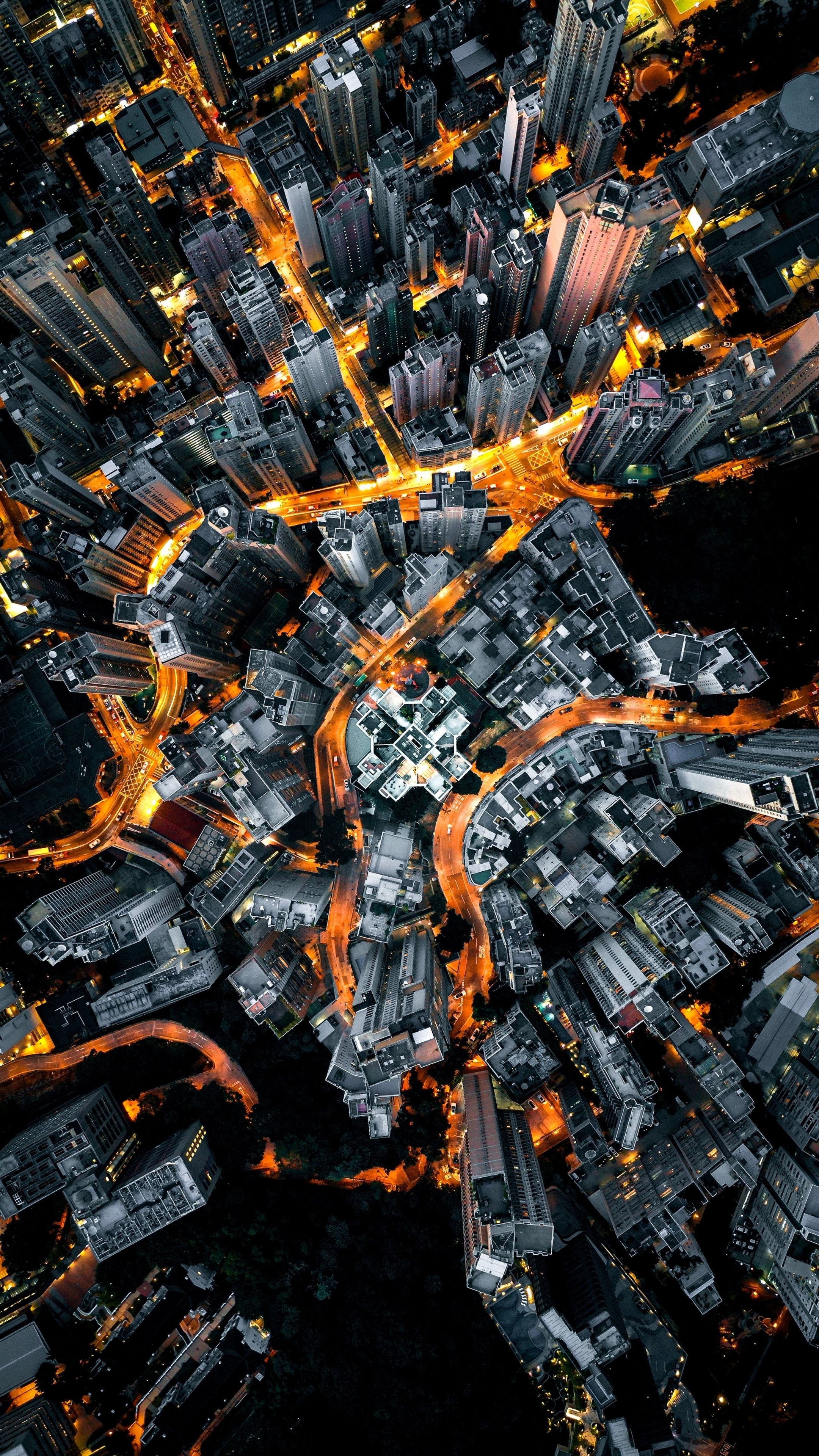 Hong Kong skyscrapers, top-down aerial cityscape, glowing amber streetlights, 4K Phone wallpaper