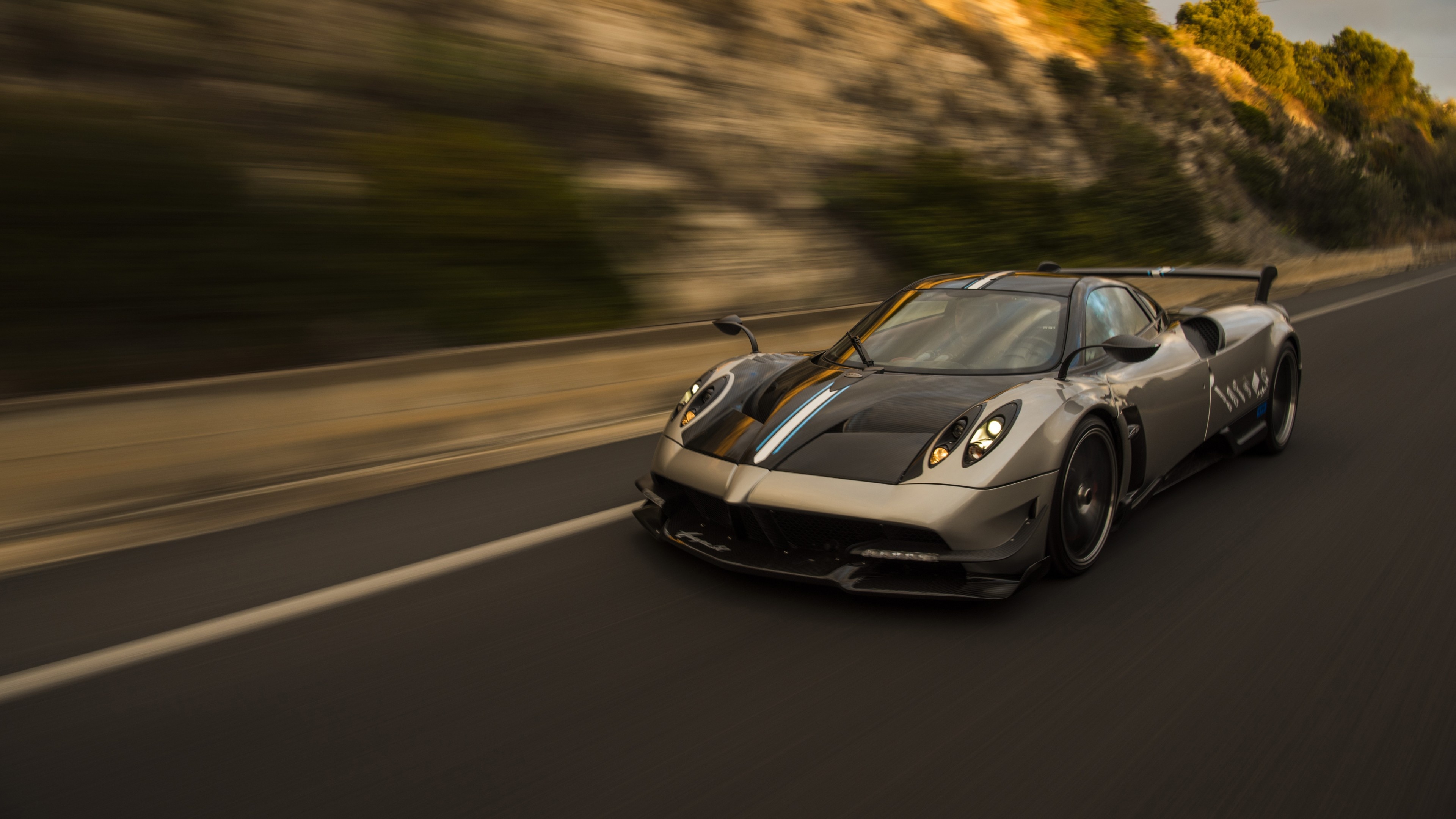 Pagani Huayra BC, Motion blur highway, Sunlit rocky hillside, 4K Desktop wallpaper