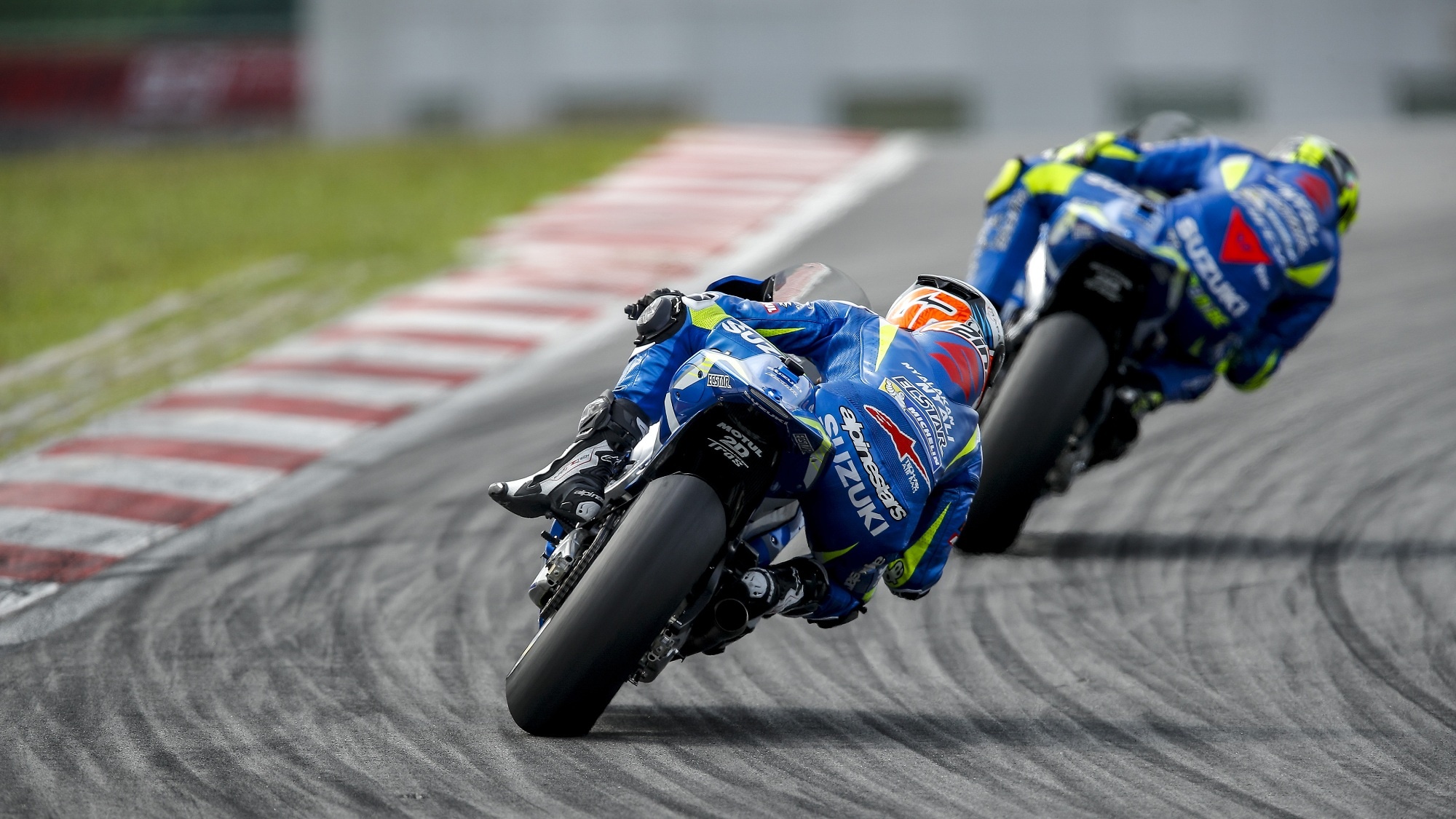 Suzuki Ecstar GSX-RR pair, Blue Suzuki team leathers, MotoGP convoy through corner, HD Desktop wallpaper