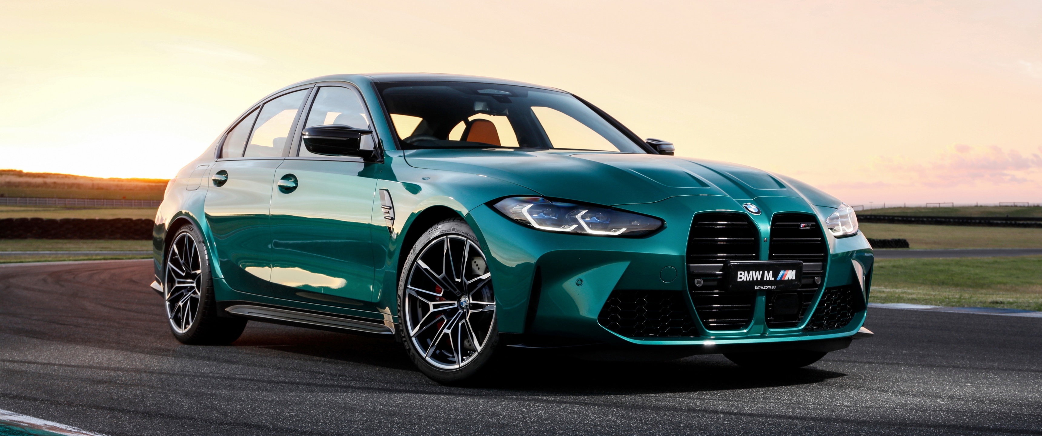 BMW M3 G80, Isle of Man Green paint, Racetrack at sunset, Dual Screen Desktop wallpaper