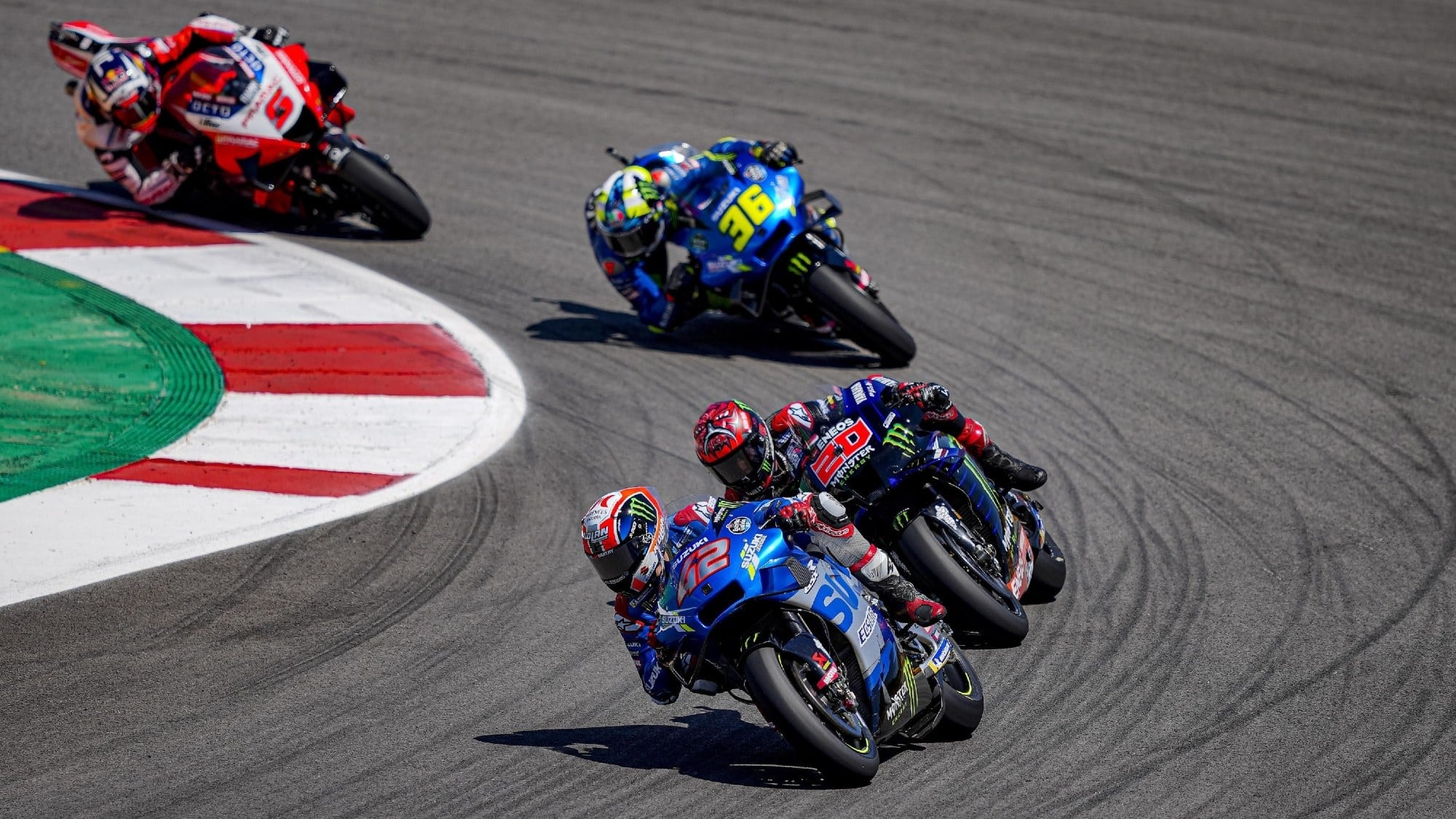 Alex Rins number 42, Fabio Quartararo number 20, Joan Mir number 36, Red Ducati trailing behind, MotoGP battle through corner, HD Desktop wallpaper