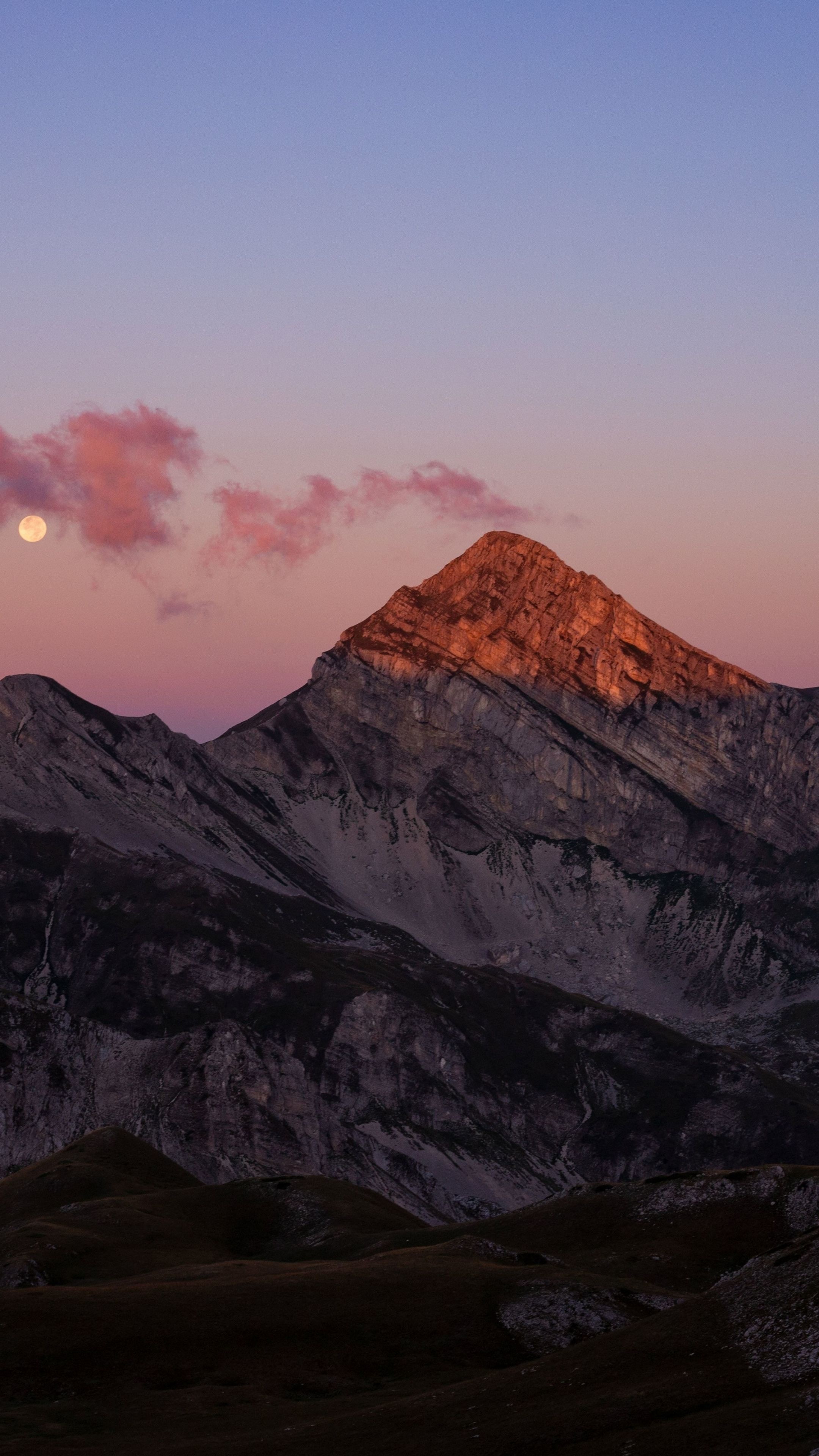 alpenglow rocky mountain peak, glowing full moon, pink dusk clouds, 4K Phone wallpaper