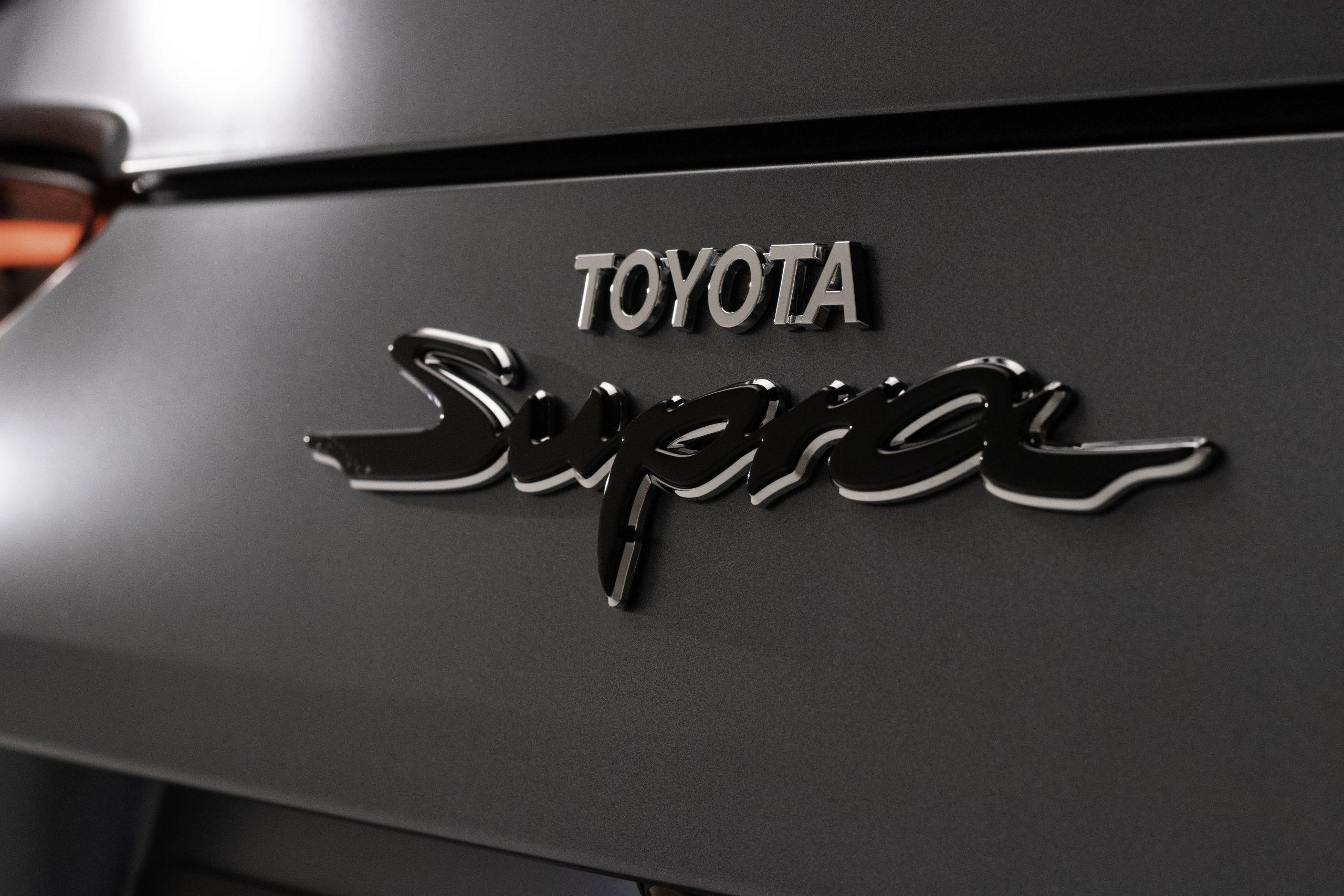 Toyota GR Supra badge, Toyota Supra script emblem, Matte grey car body, HD Desktop wallpaper