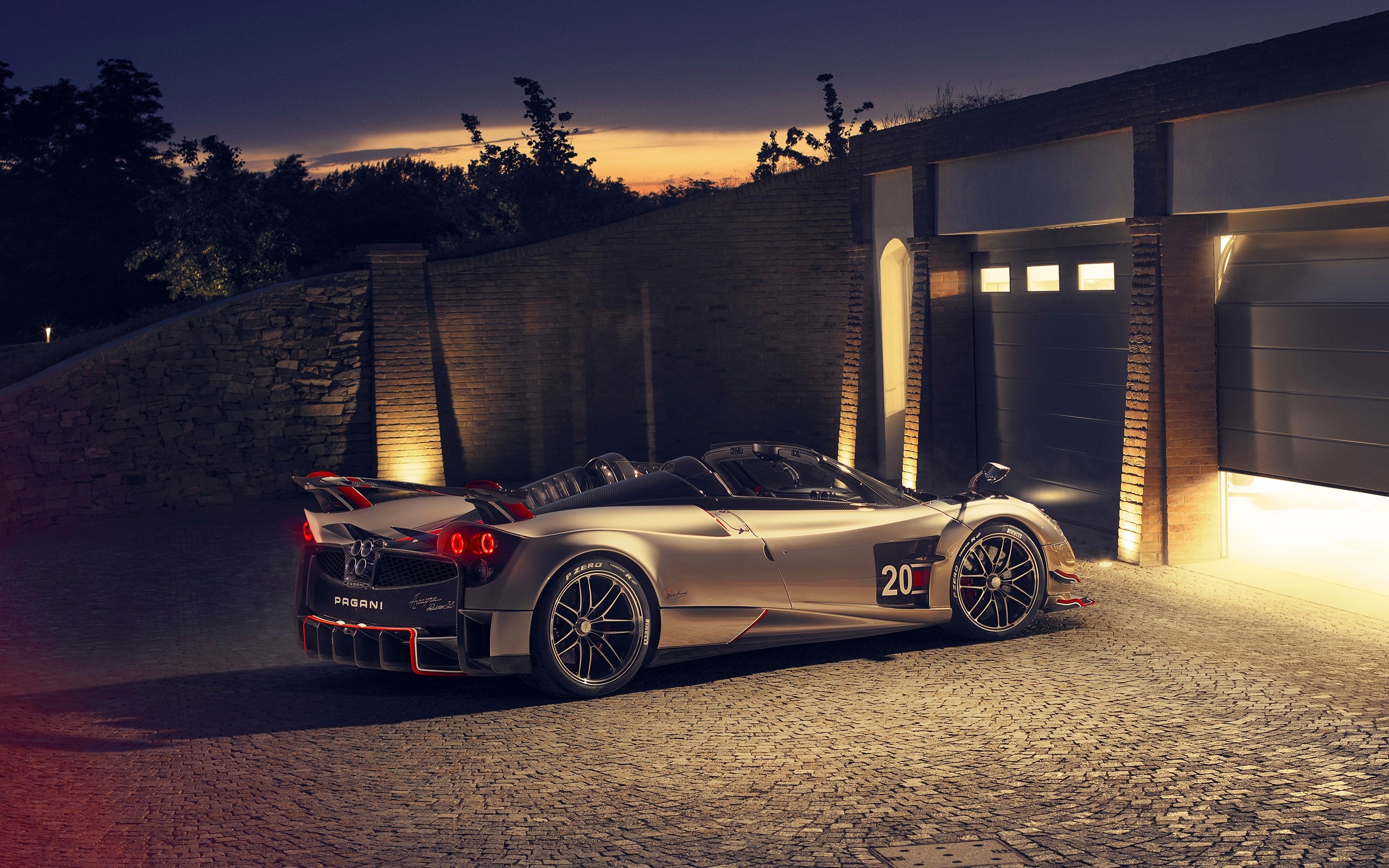 Pagani Huayra Roadster BC, cobblestone driveway at dusk, illuminated brick garage, HD Desktop wallpaper