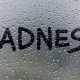 Sadness text on glass